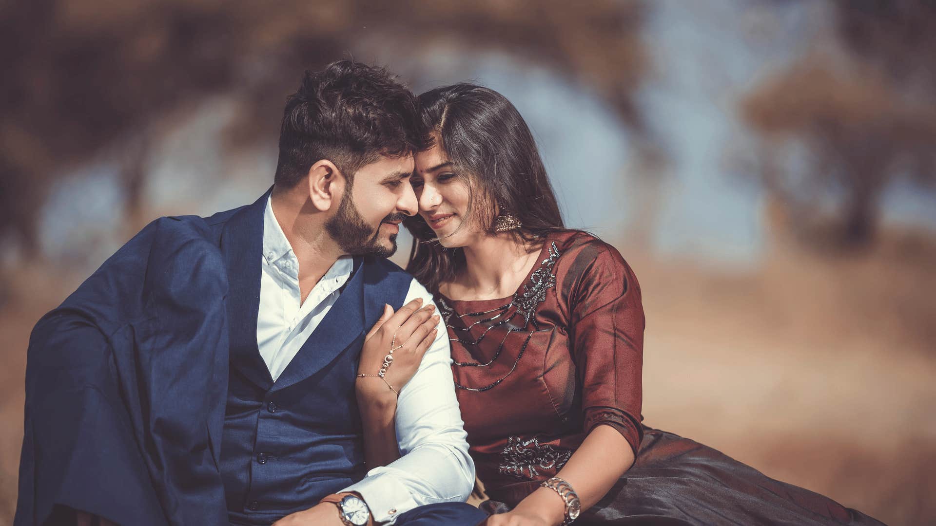 man and woman sitting on ground 