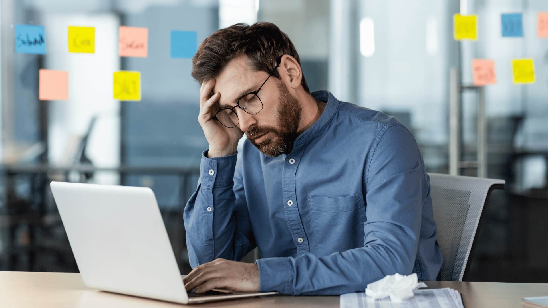 man stressed while staring at laptop