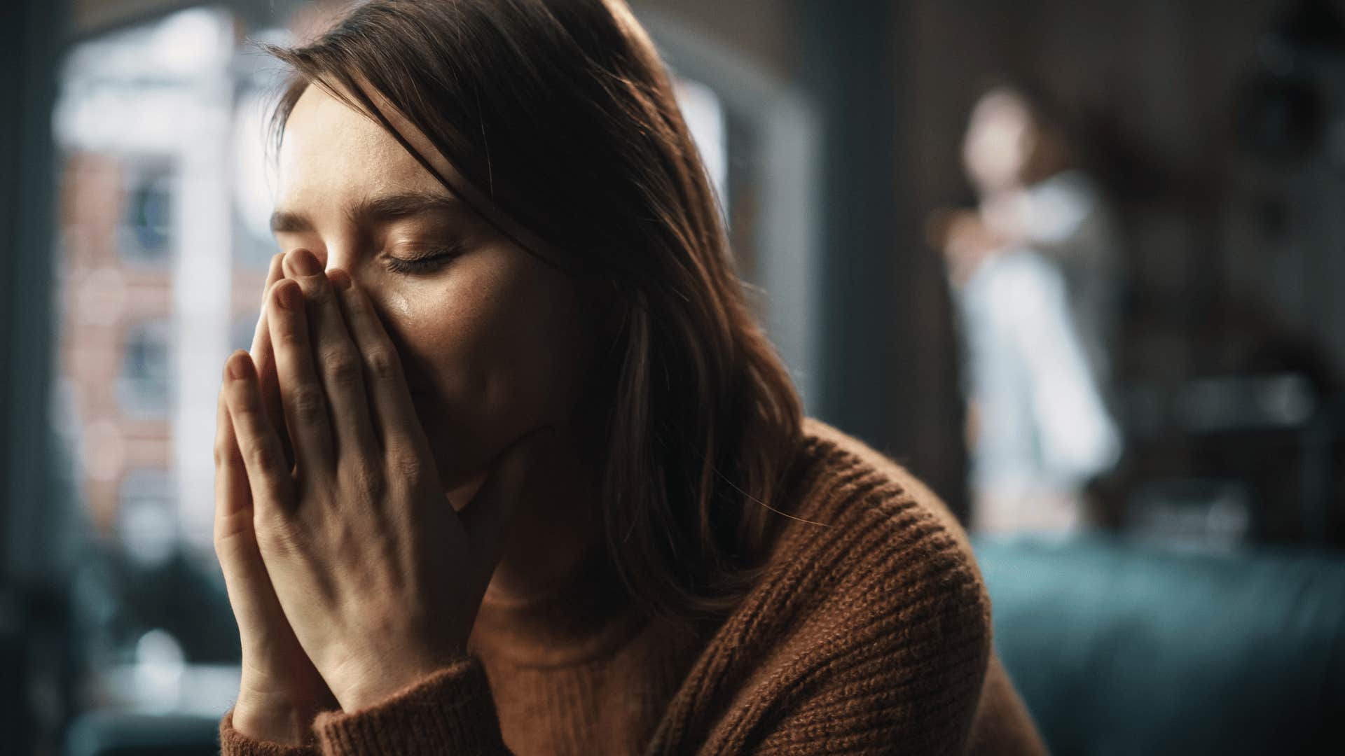 woman upset while man yells at her