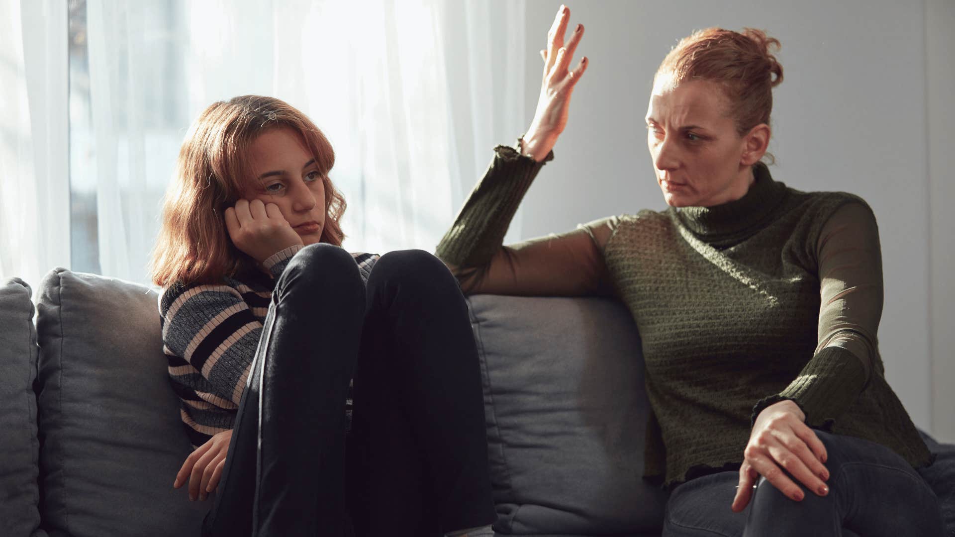 mother arguing with daughter while daughter looks done