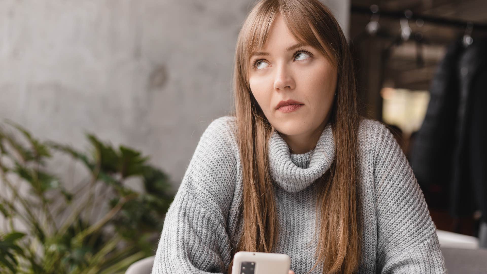 Woman looking annoyed while texting on her phone