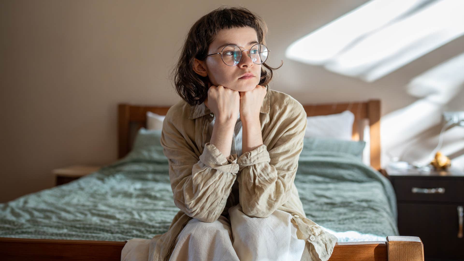 Woman looking sad staring out a window