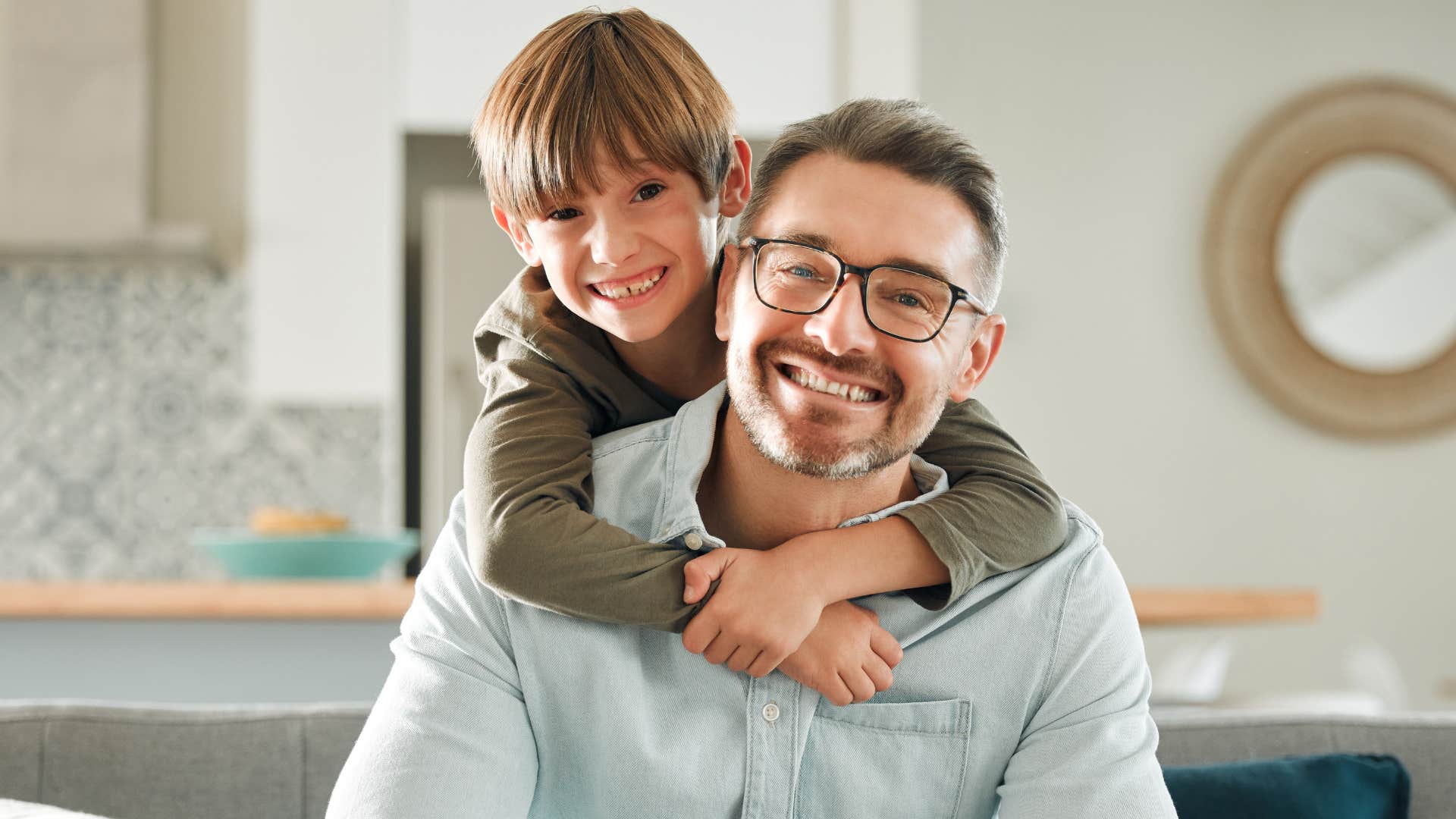 Young boy hugging his smiling father