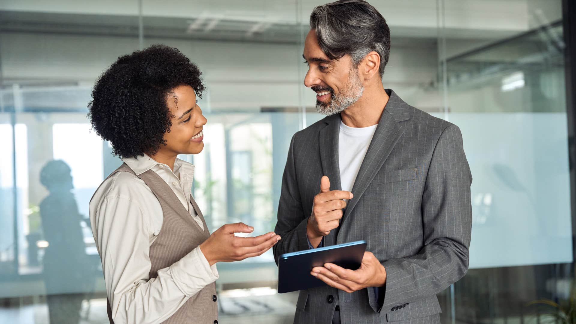 Co-workers talking happily at work