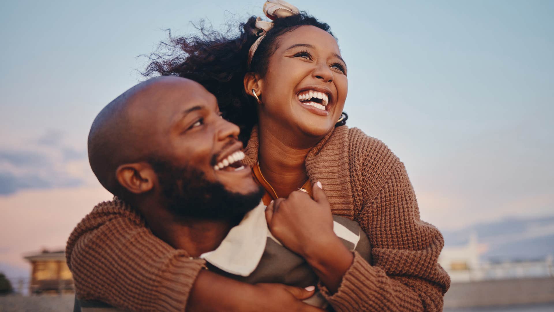 Couple smiling and hugging each other.