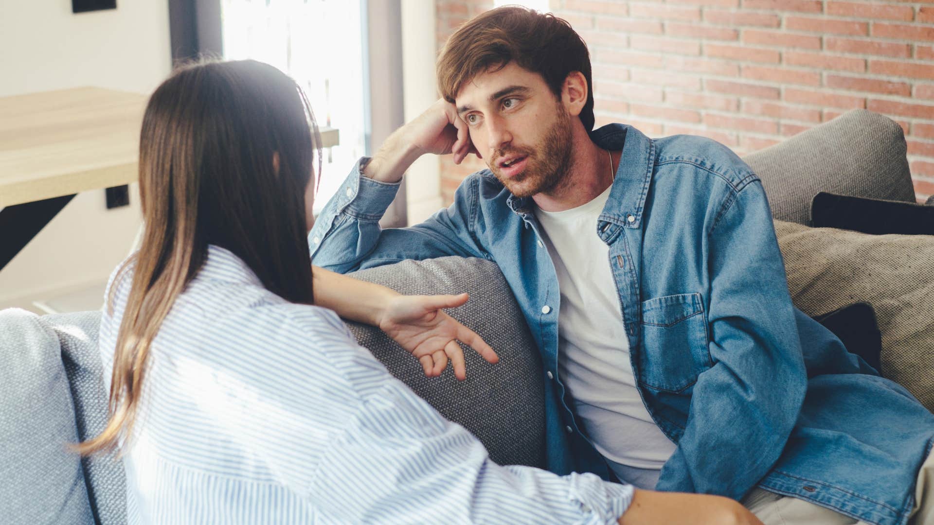 Couple having a serious conversation on the couch