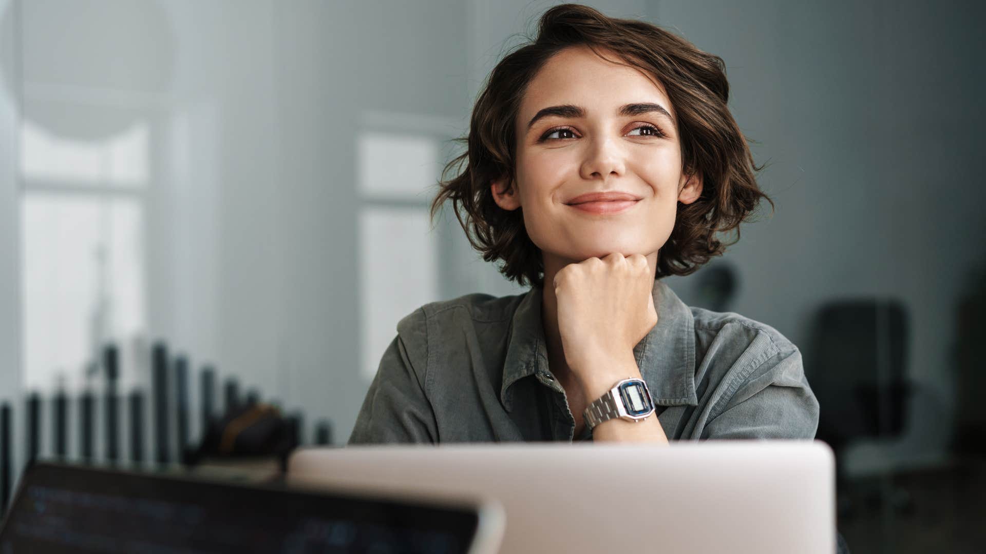 Woman looking happy sitting at her work desk