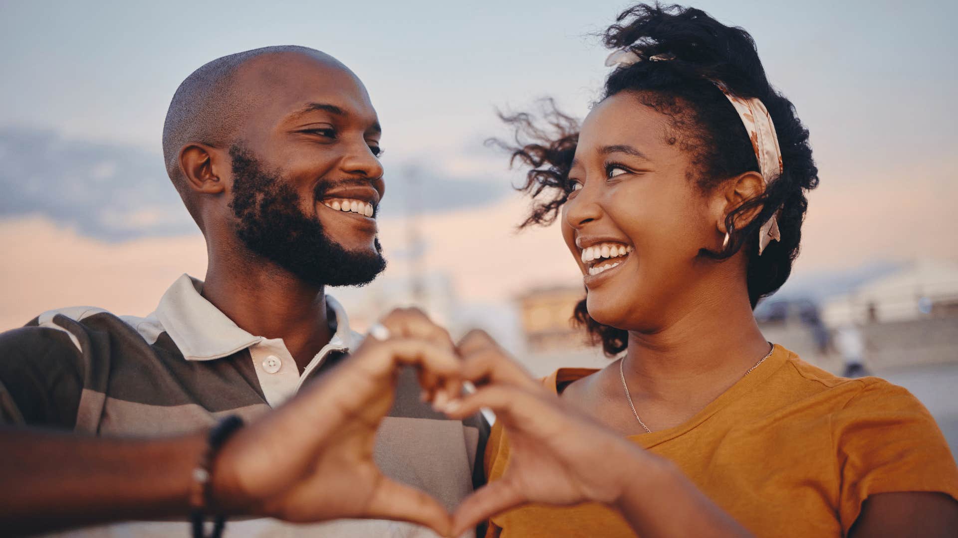 couple making a heart with their hands