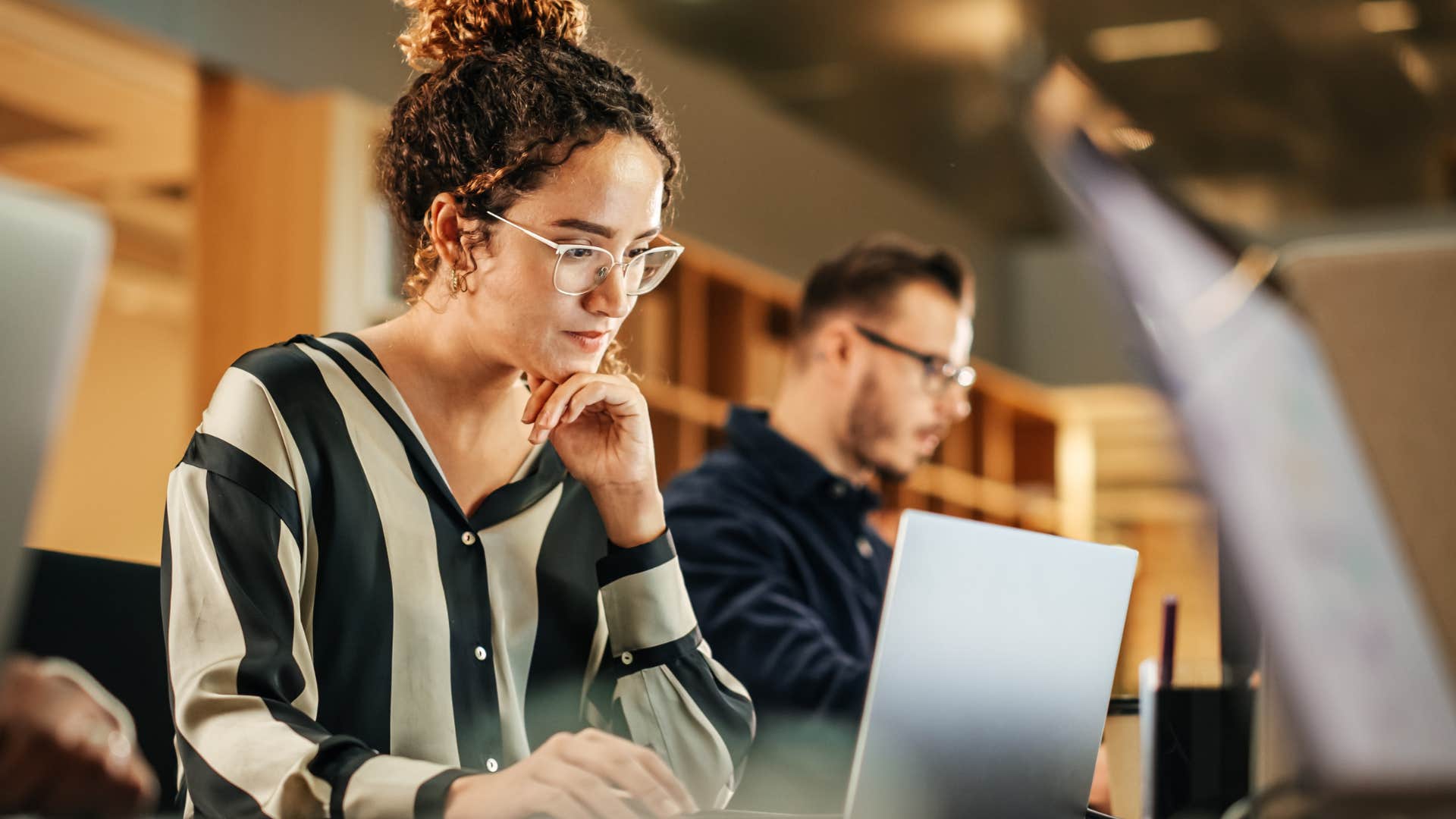 Woman working hard at her laptop in an office.