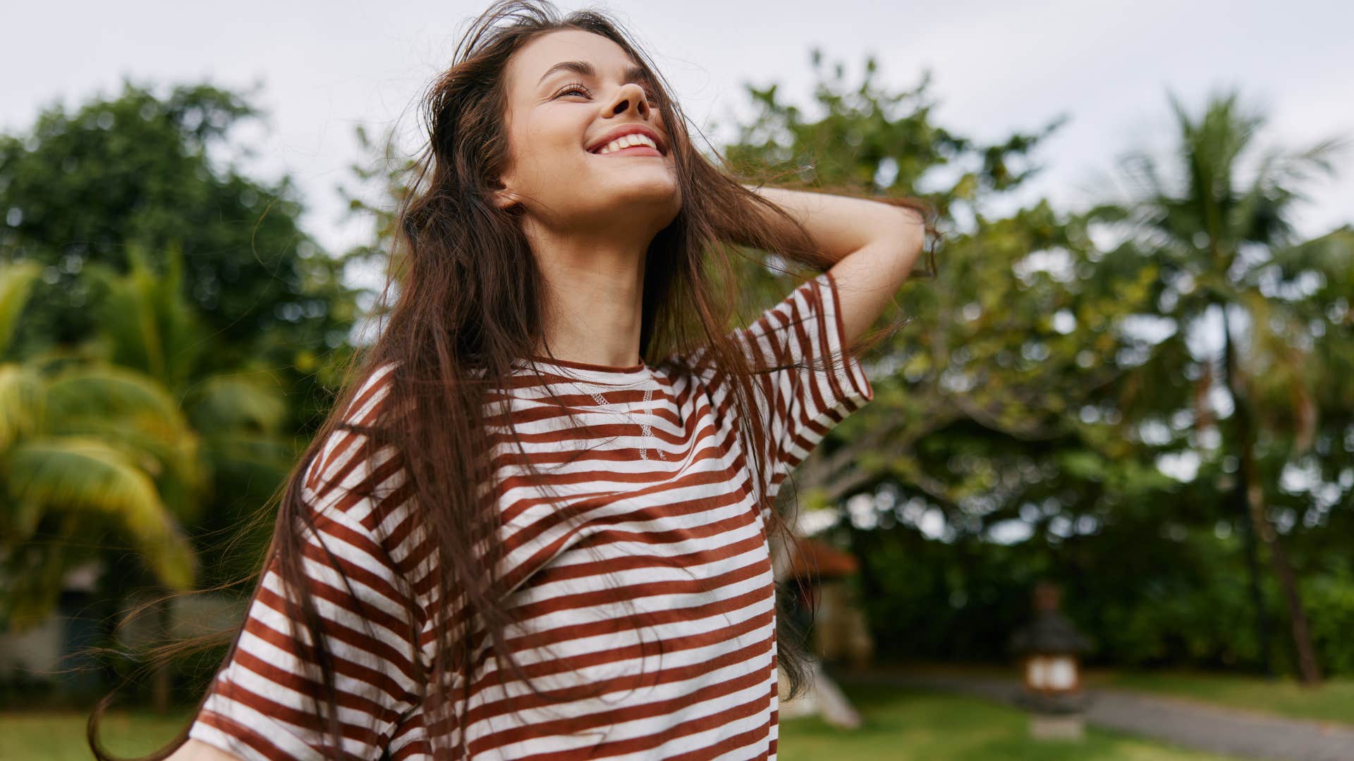 Woman smiling and walking around outside.