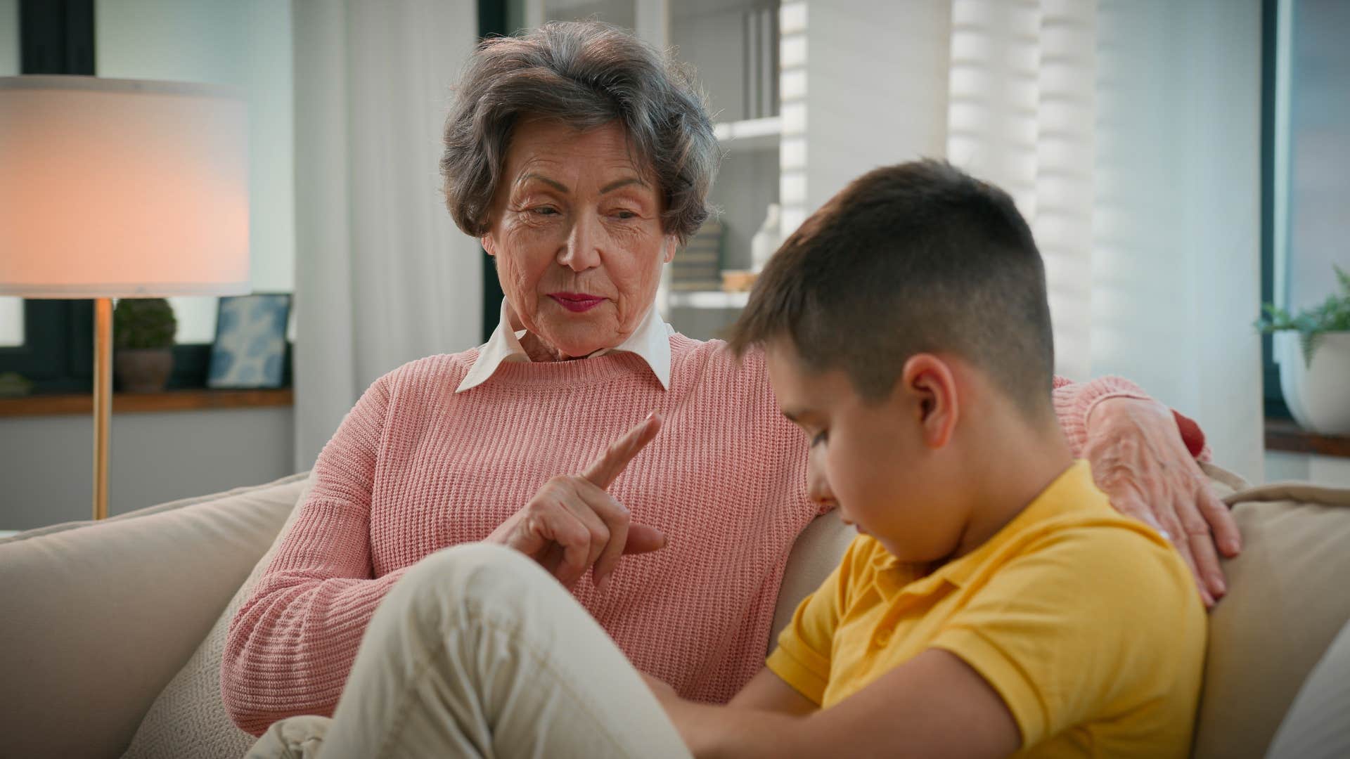 Woman pointing her finger at an upset boy