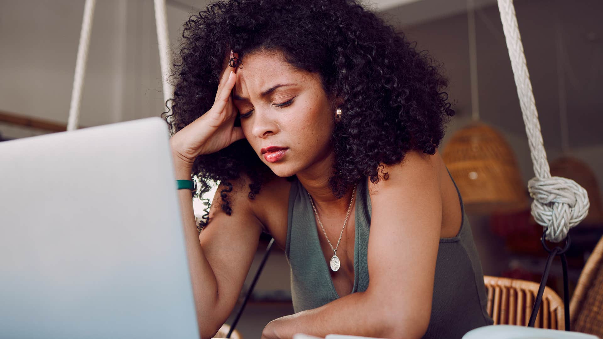 Stressed woman sitting in front of her laptop