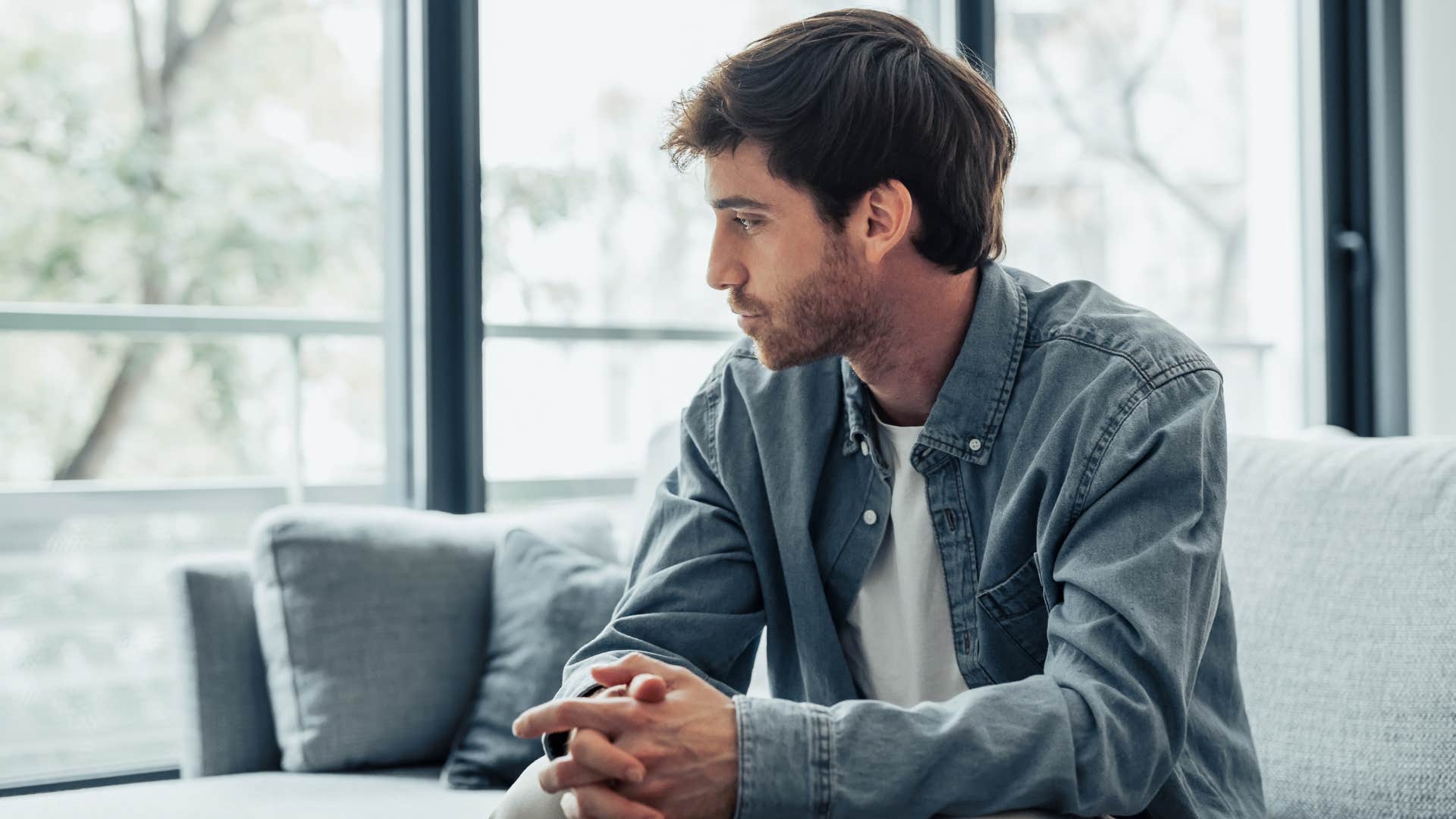 Adult man looking sad on the couch