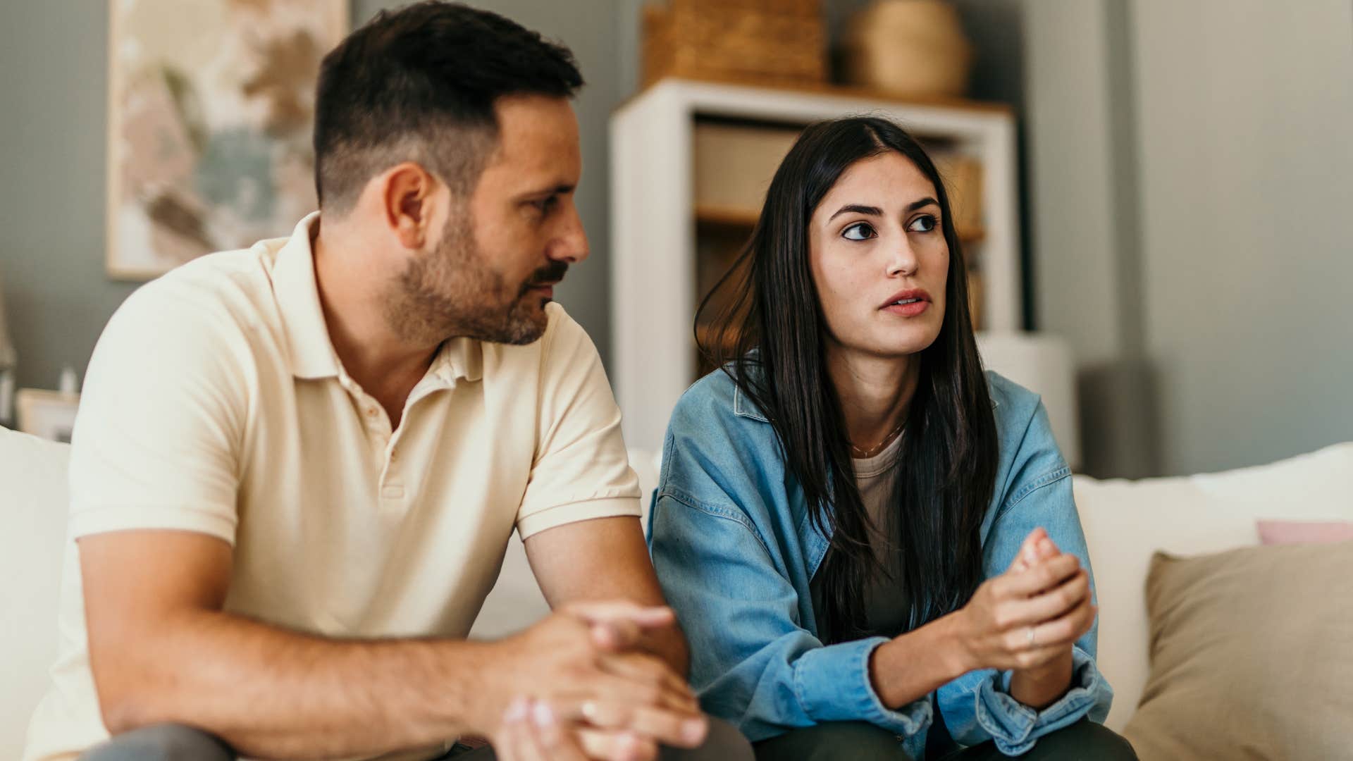 Woman and her boyfriend sitting on the couch together