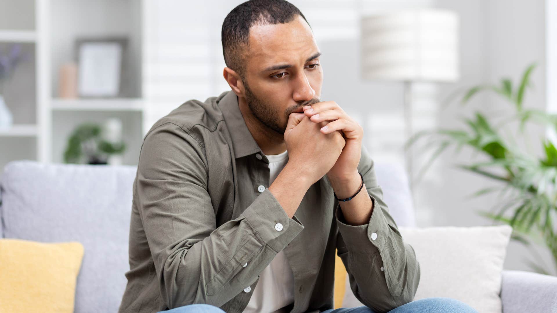 Man looking upset with his head in his hands