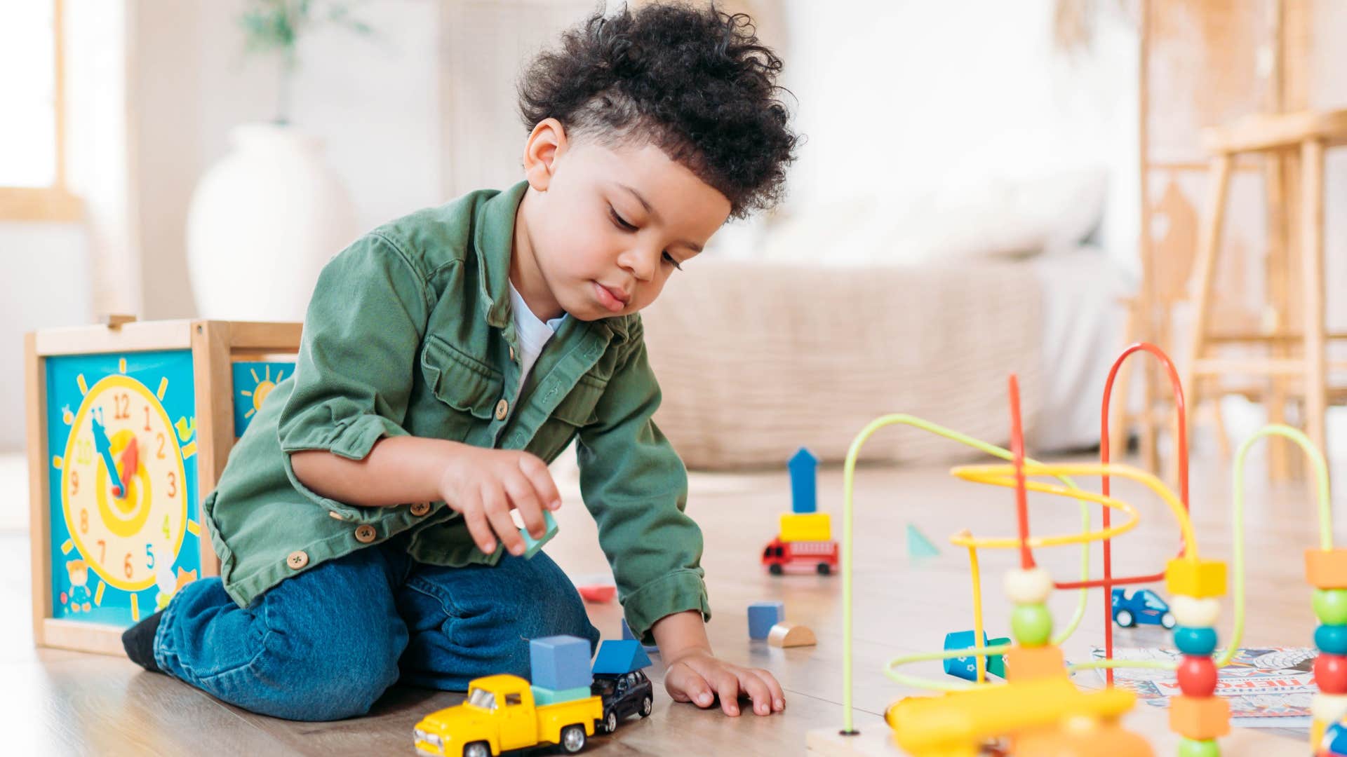 Little boy playing with toys on the floor