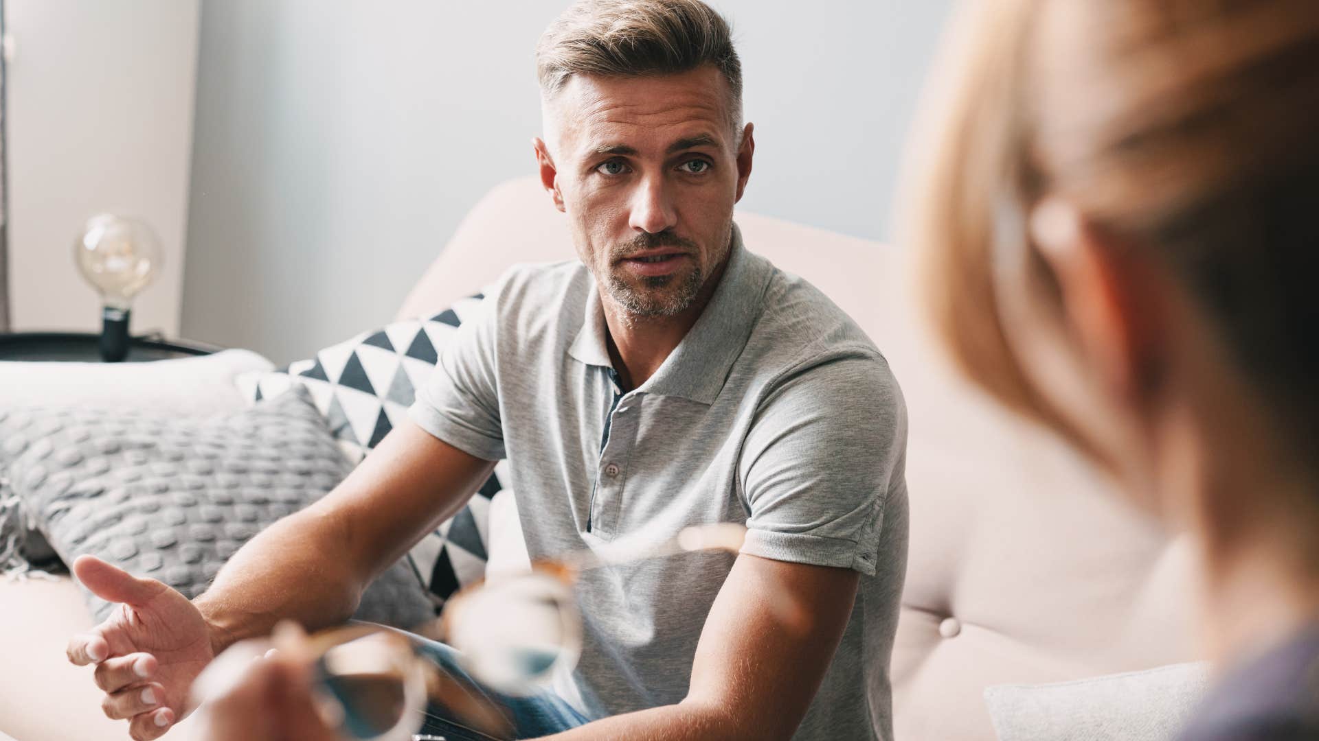 Man looking upset talking to his partner.