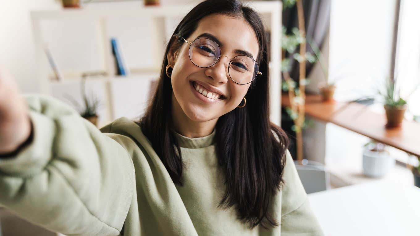 Young woman smiling at the camera in her home.