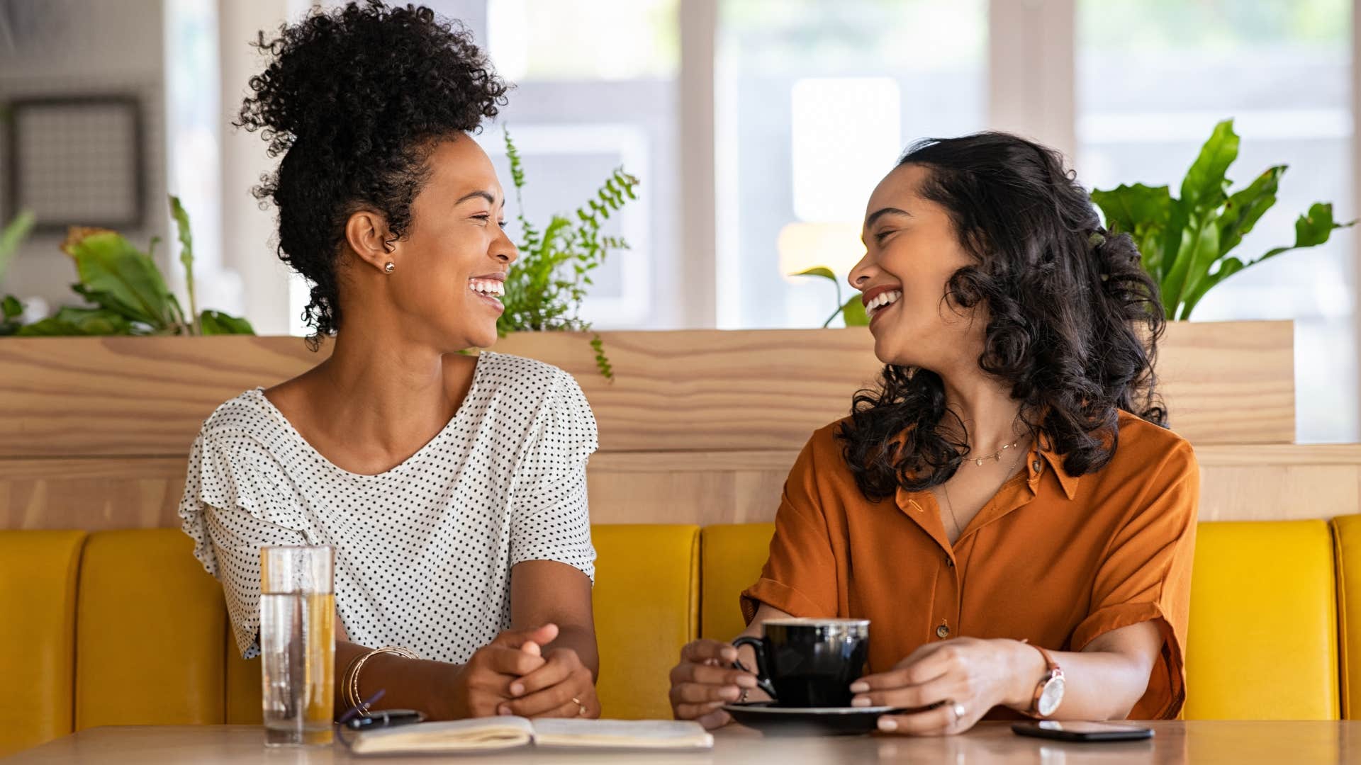 Two women talking to each other and smiling