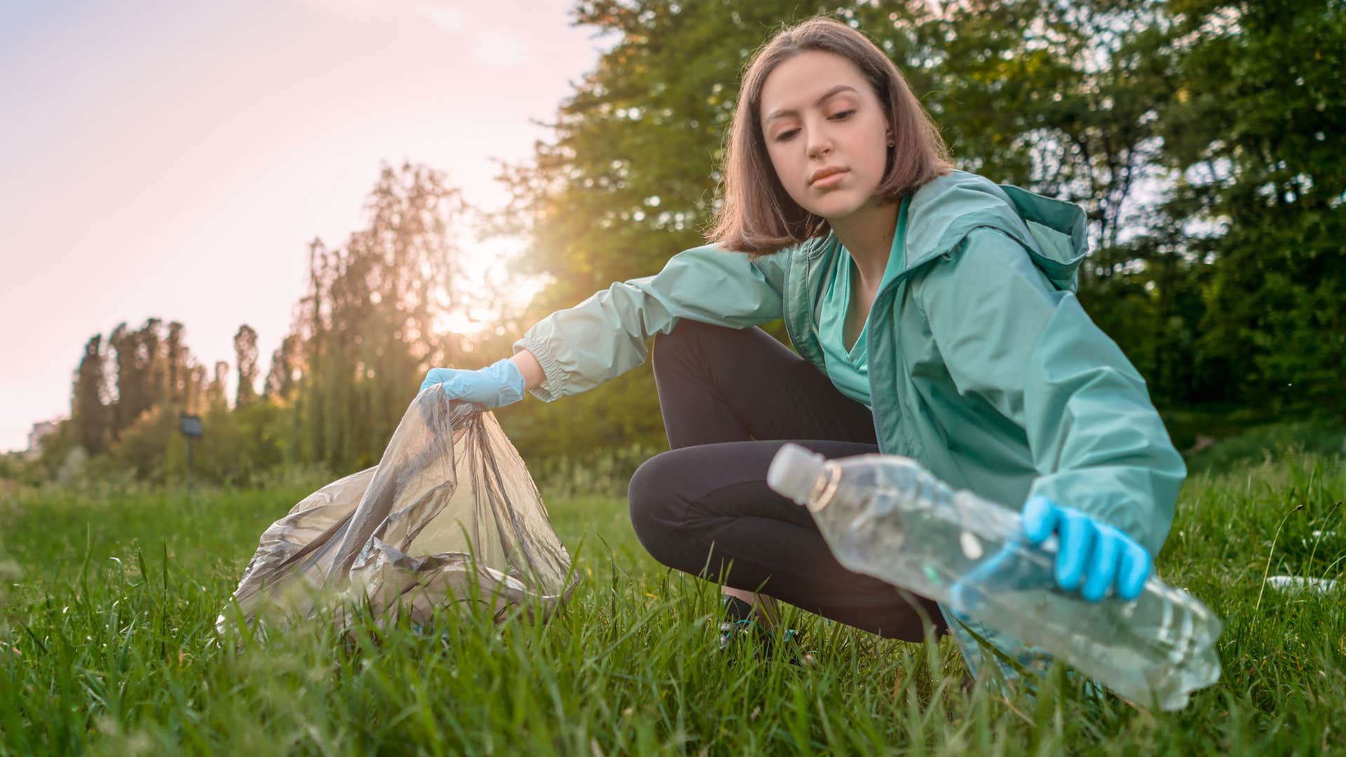 Woman picking up trash outside