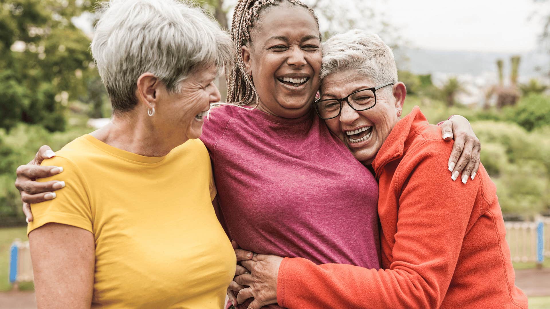 older women hugging and laughing