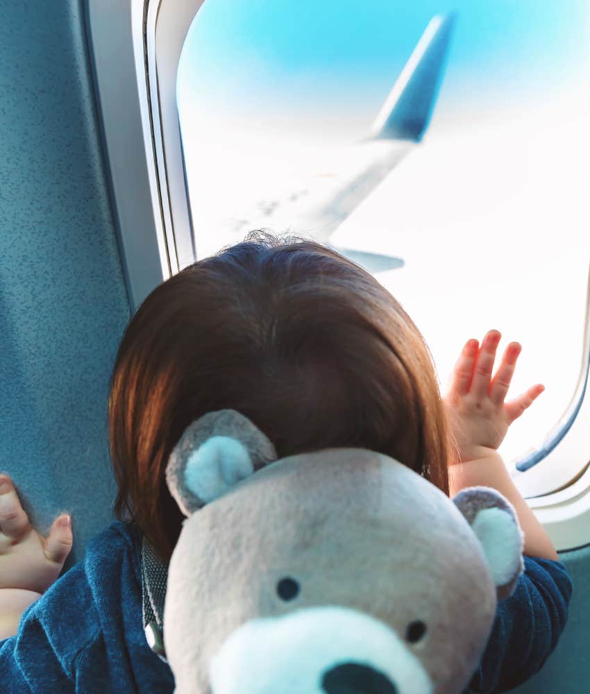 toddler looking out plane window