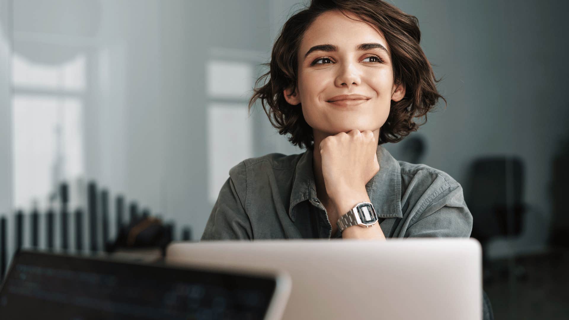 woman smiling in front of laptop