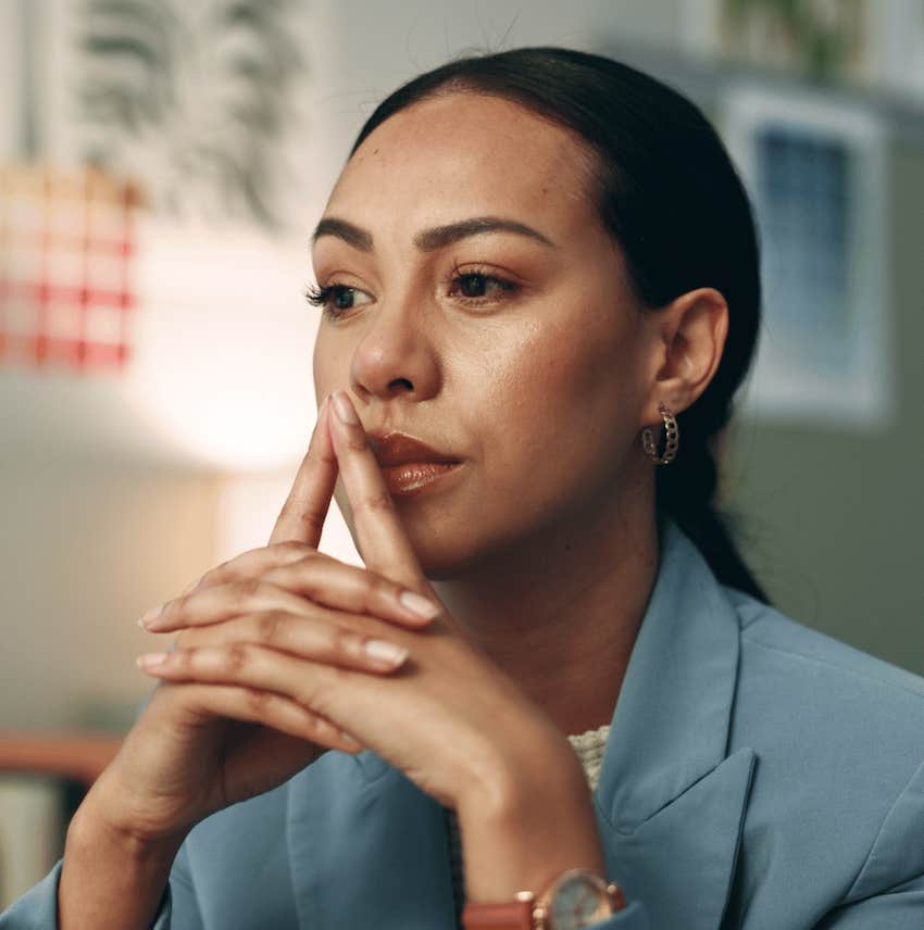 Woman crosses hand in front of face and think about how to apply wisdom to save her marriage