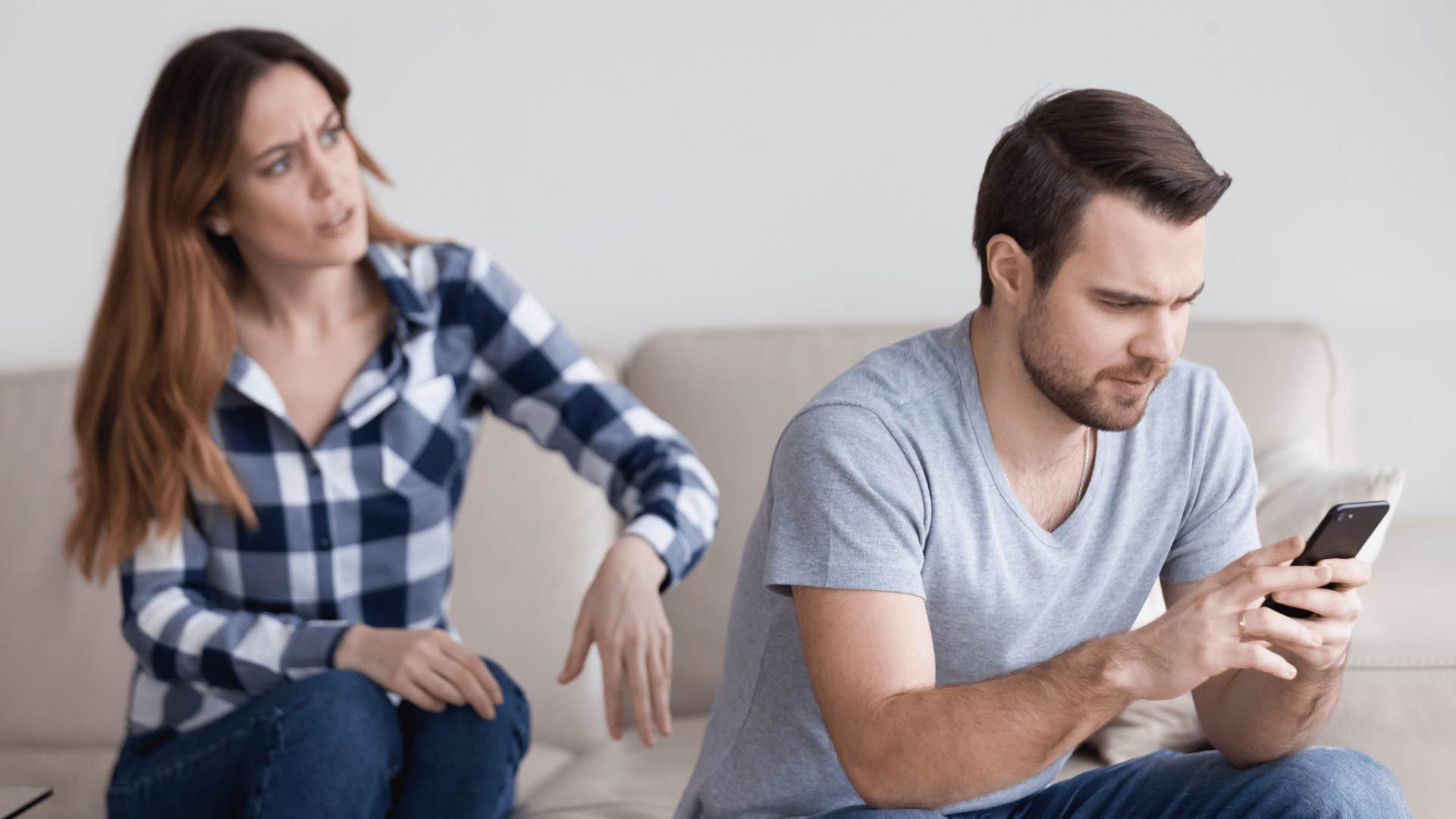 man on phone ignoring woman