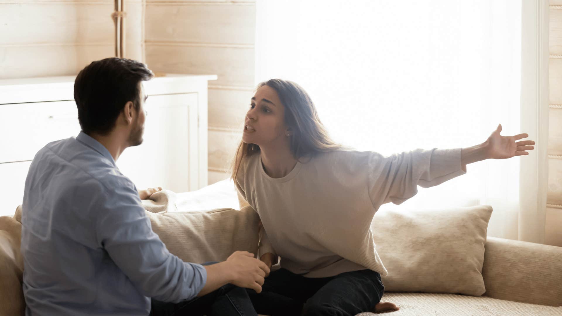 couple arguing on the couch