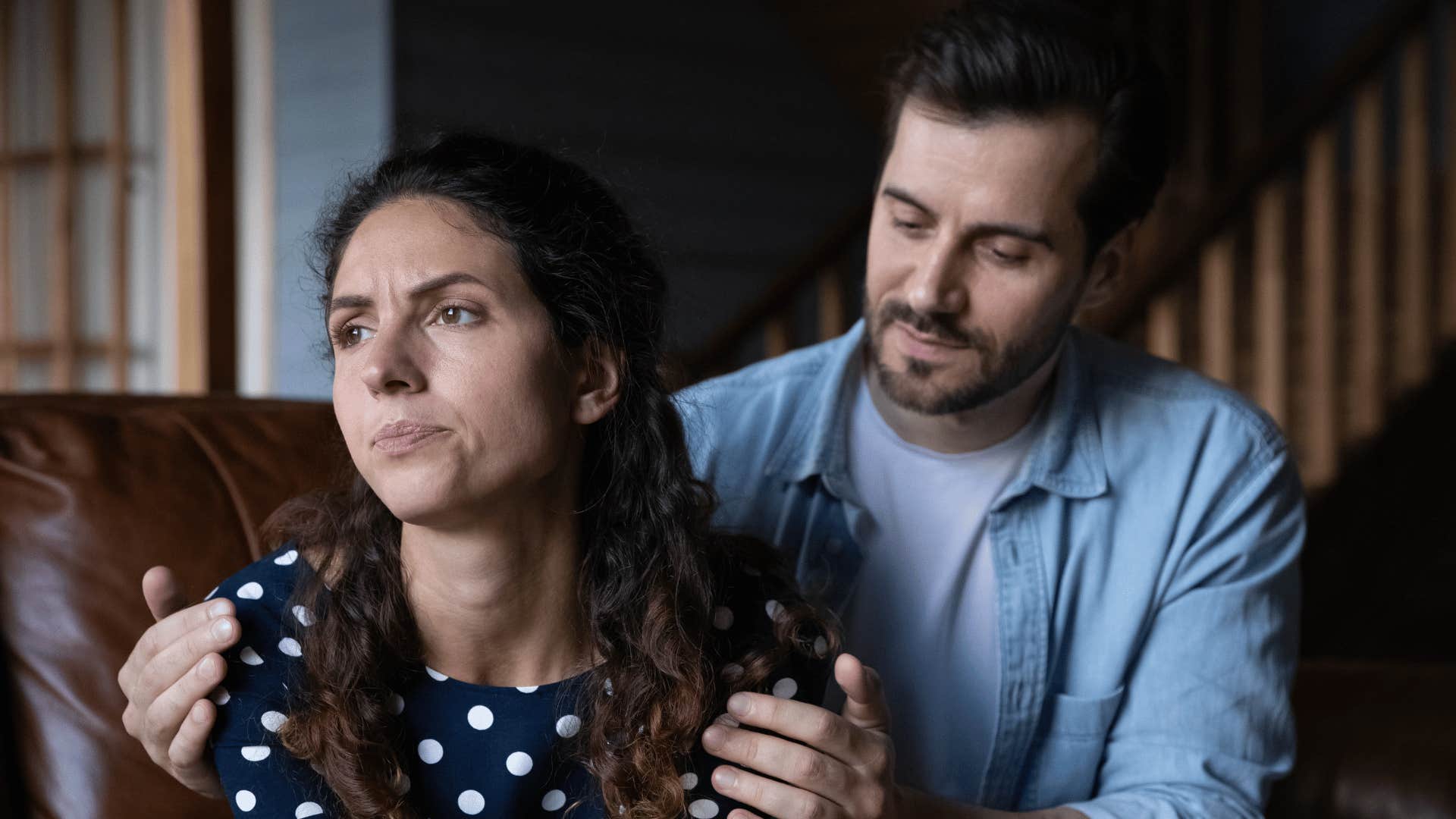 woman ignoring man trying to hug her