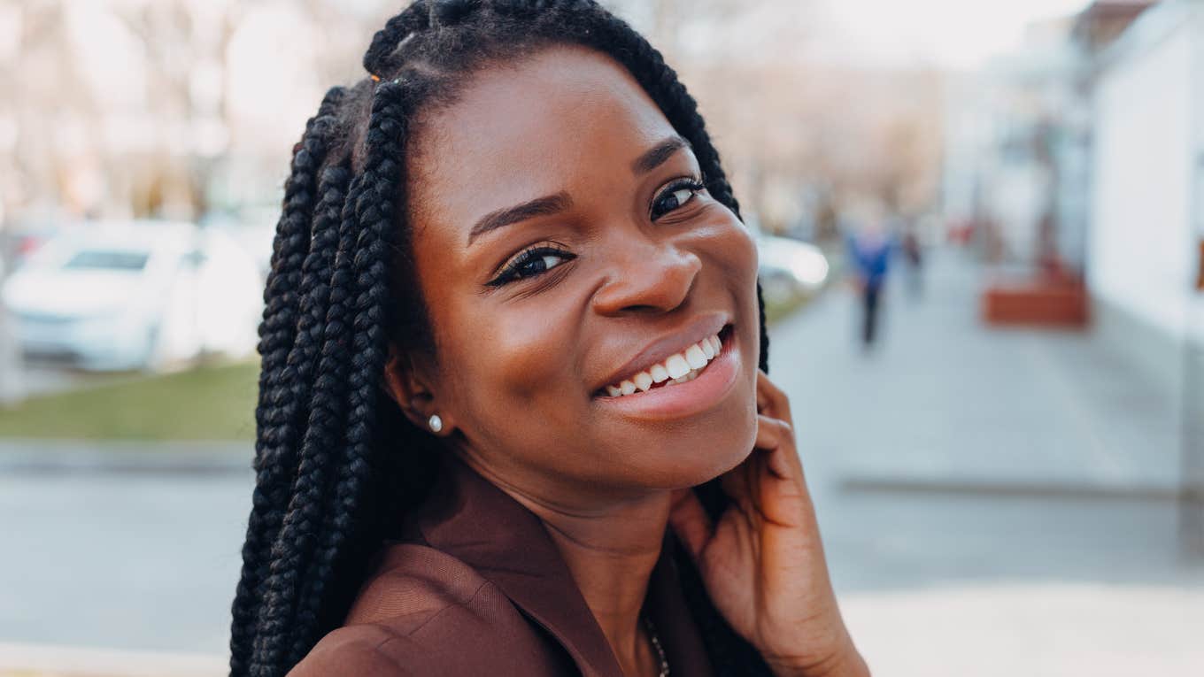 beautiful woman with braids smiling big