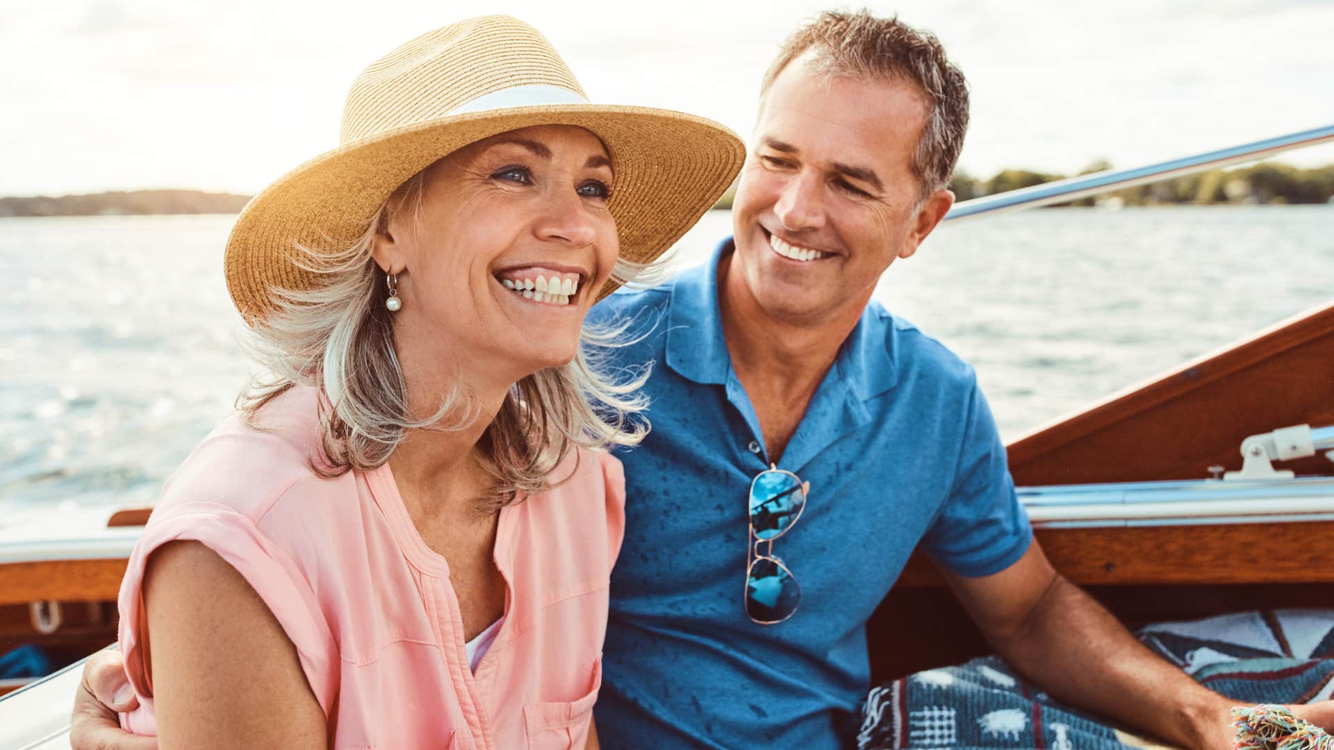 Woman smiling next to her husband on a boat.