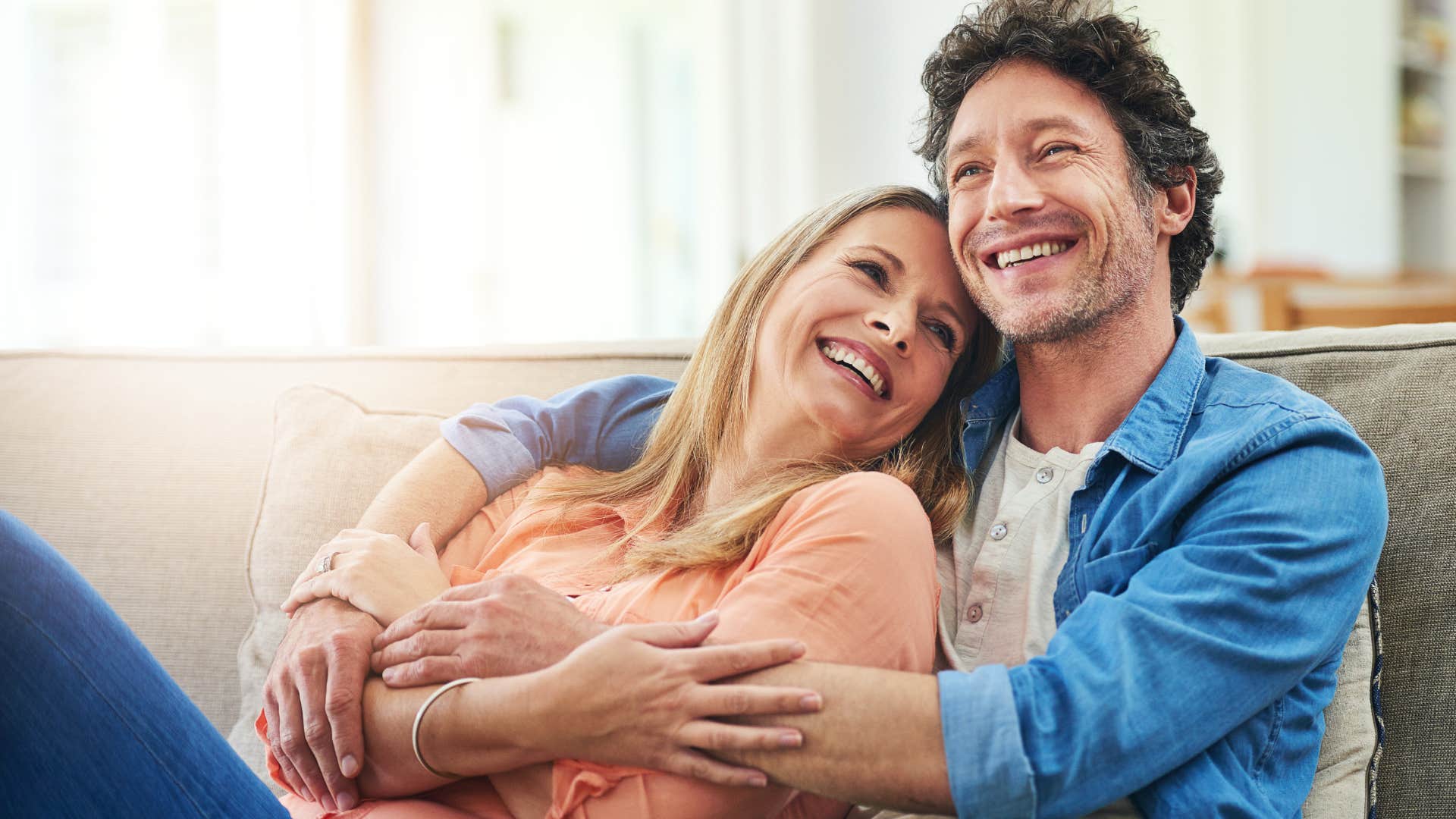 Woman cuddling with her husband.