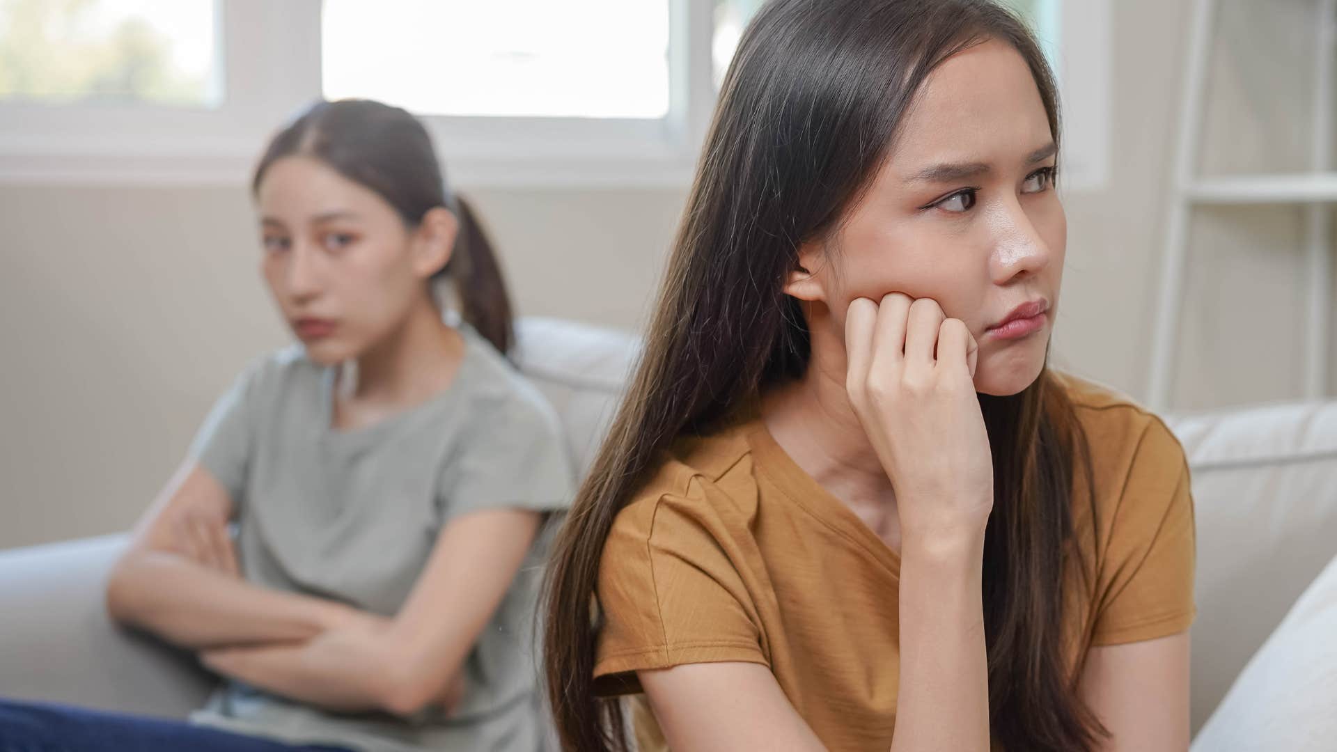 Woman looking upset turned away from her partner