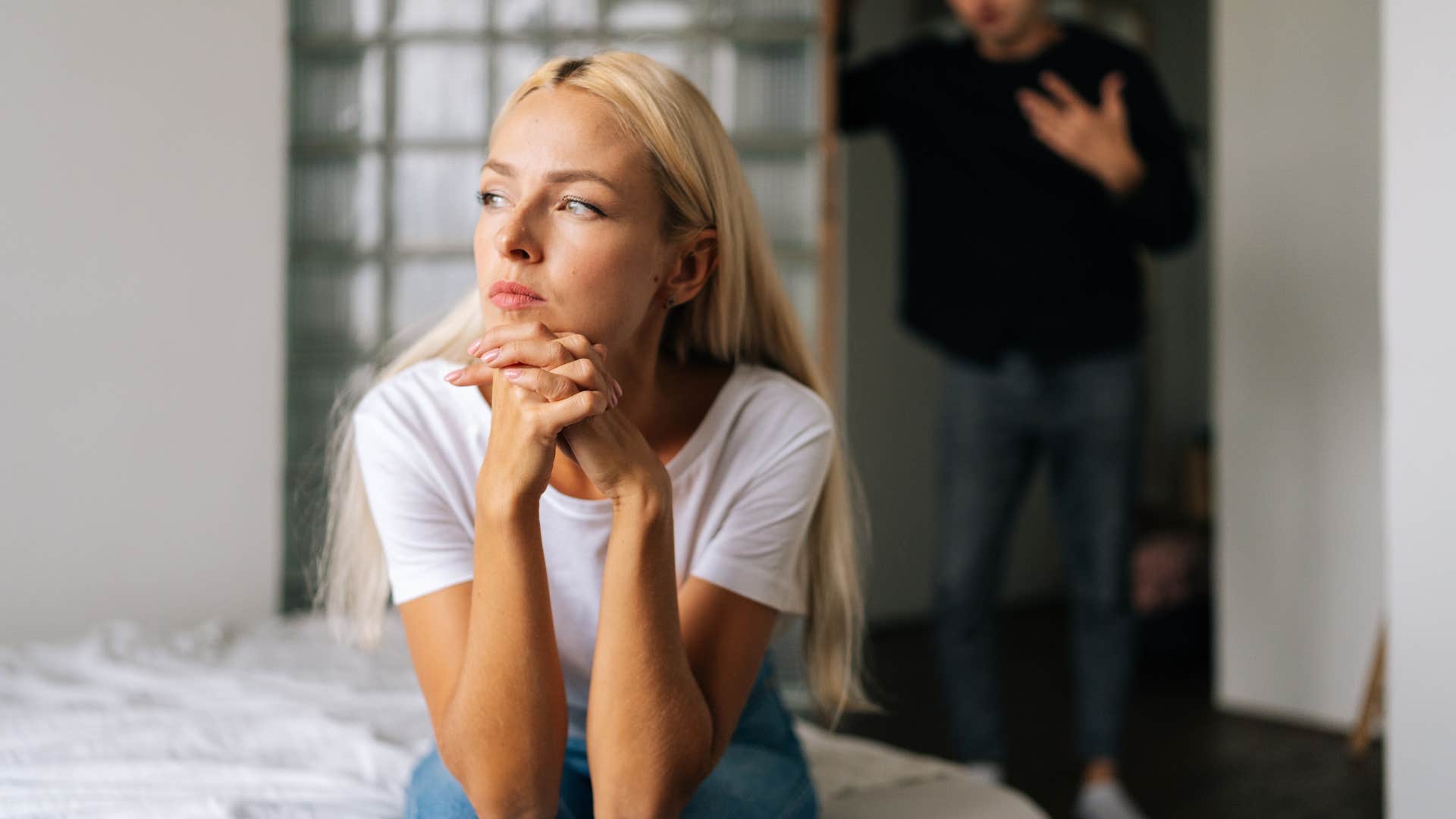 Woman looking out the window upset