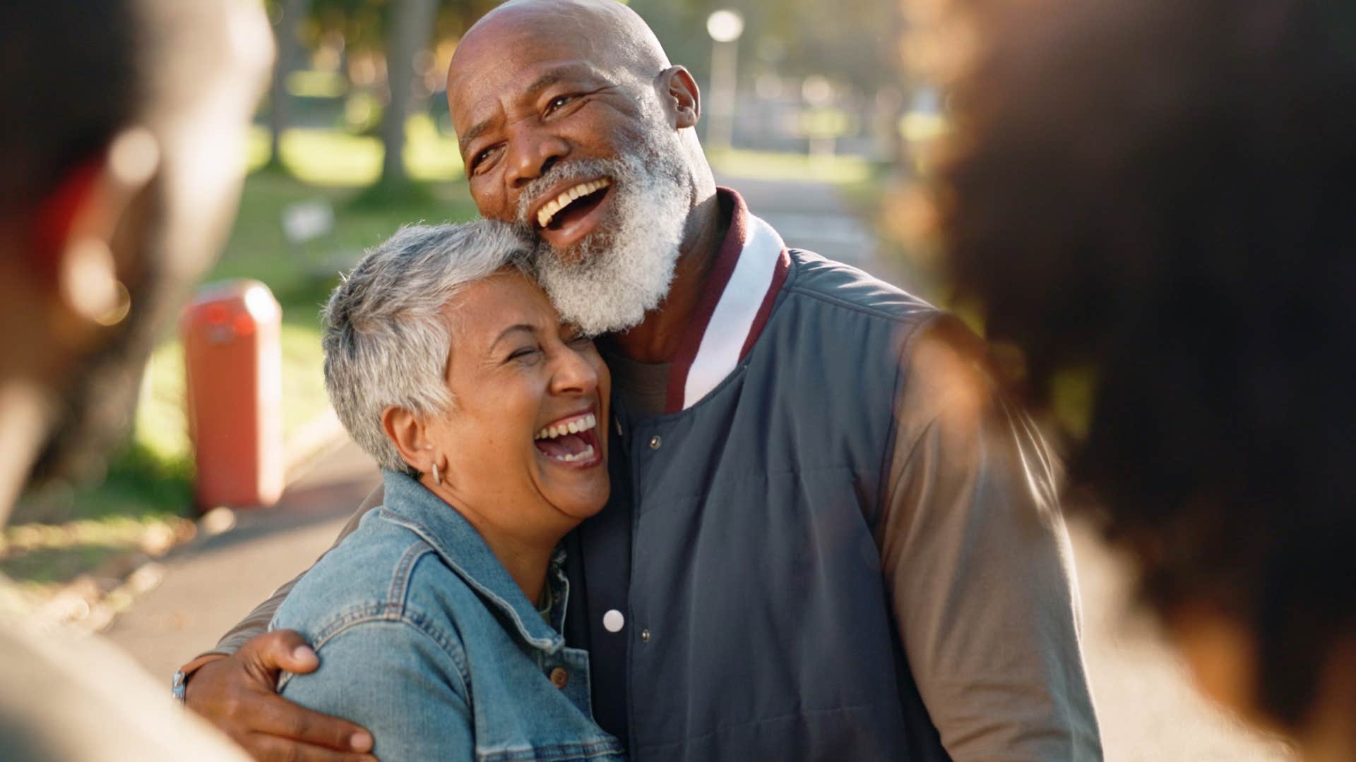 Older couple smiling and hugging each other.