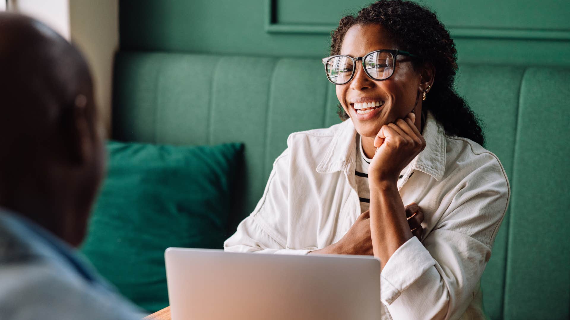 Woman smiling and looking at a man. 