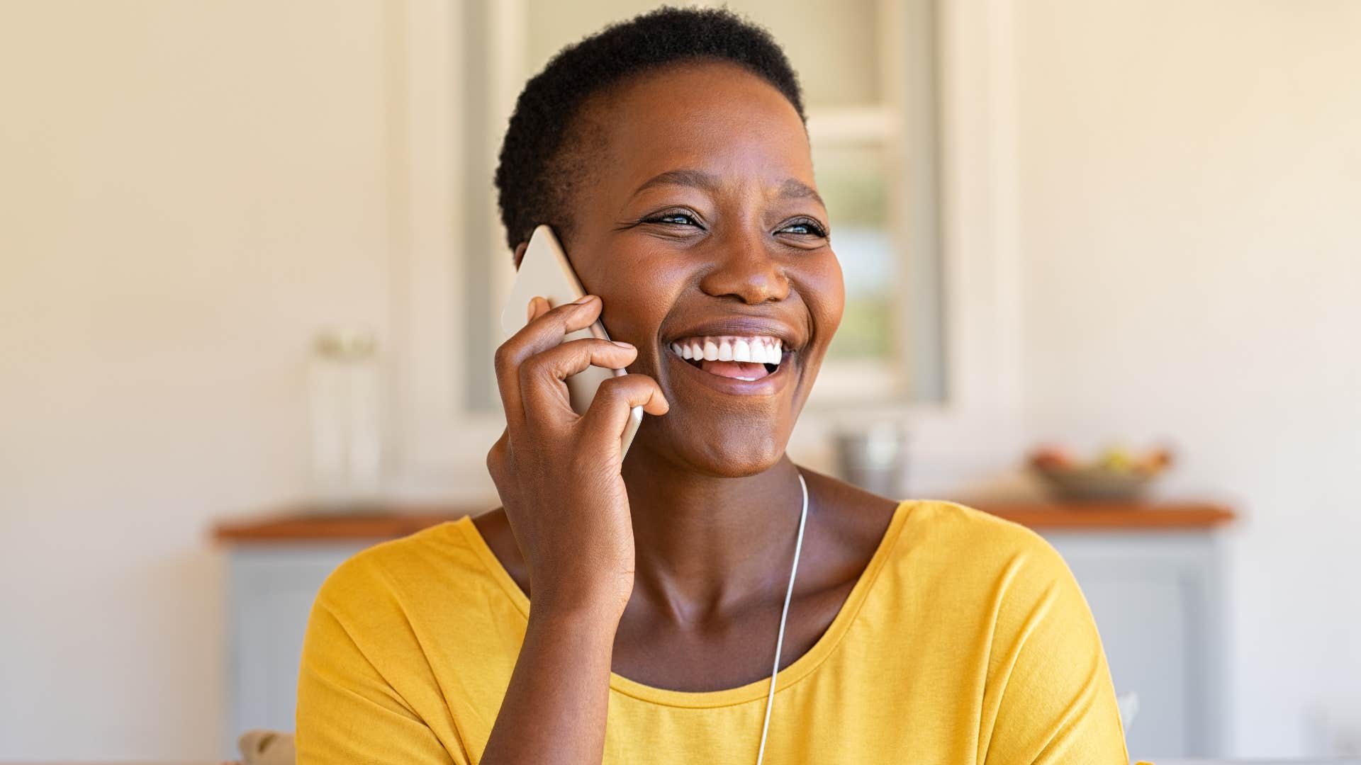 Smiling woman talking on the phone.