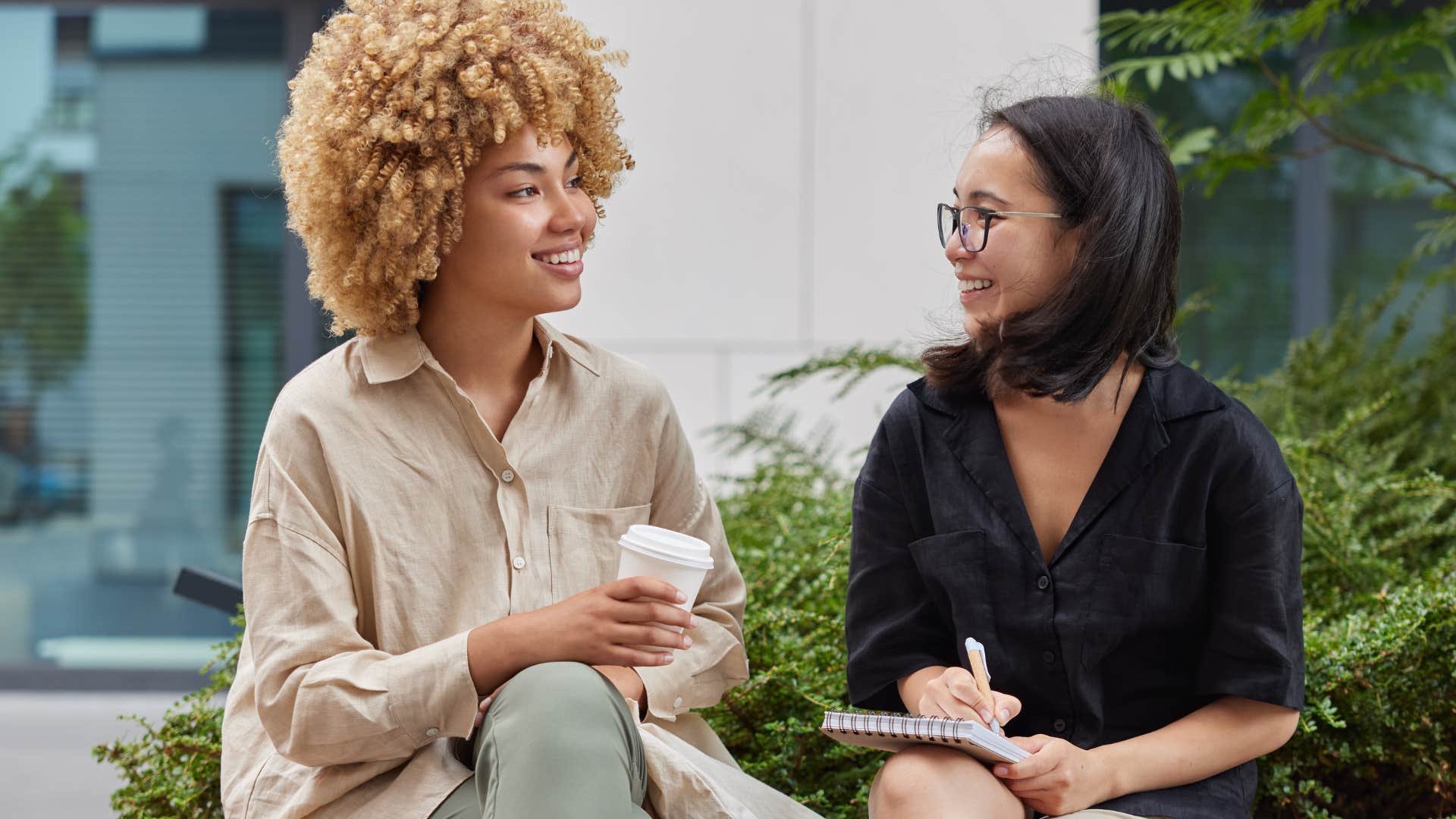 Two women smiling and talking together.