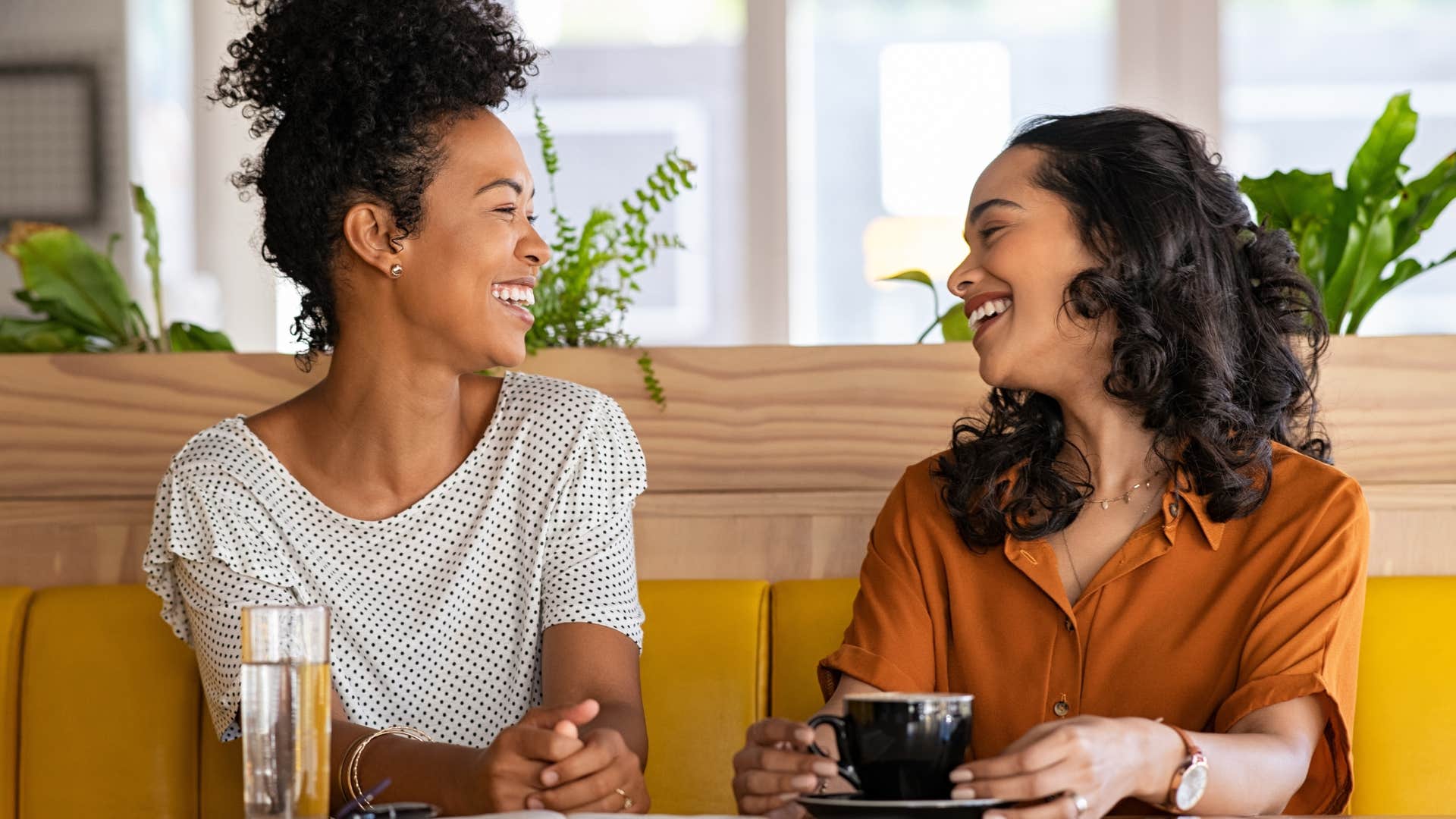 Two women smiling and laughing at each other.