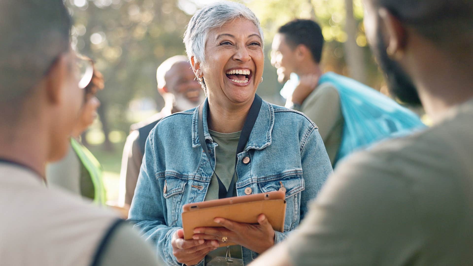 Older woman smiling at two men.