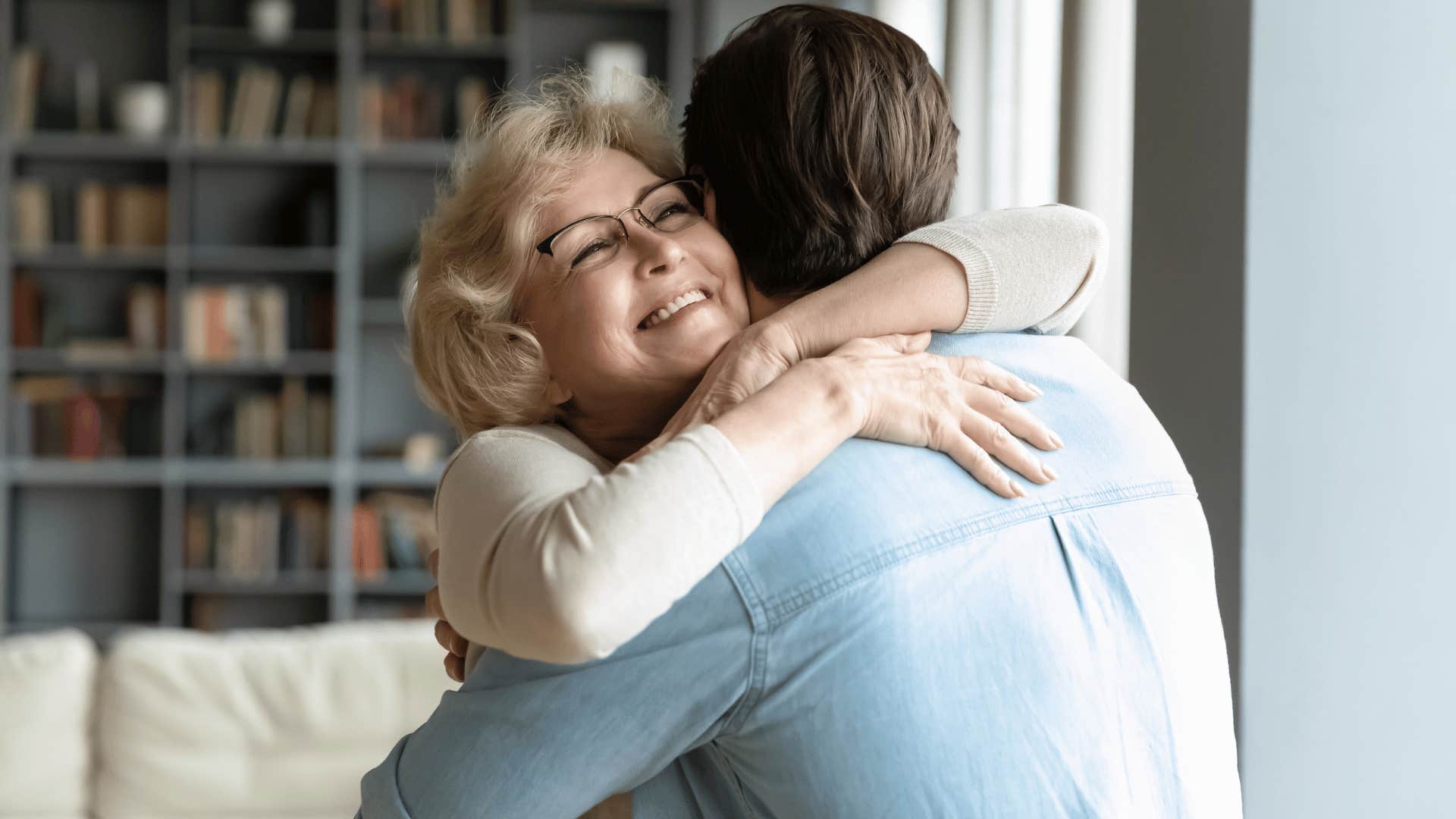 mother hugging son while smiling