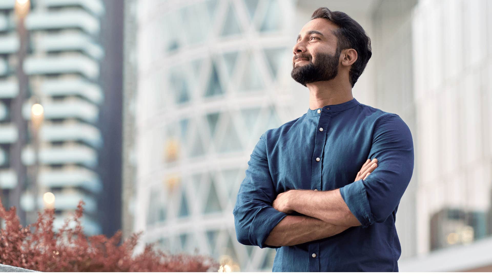 man crossing arms while looking confident 