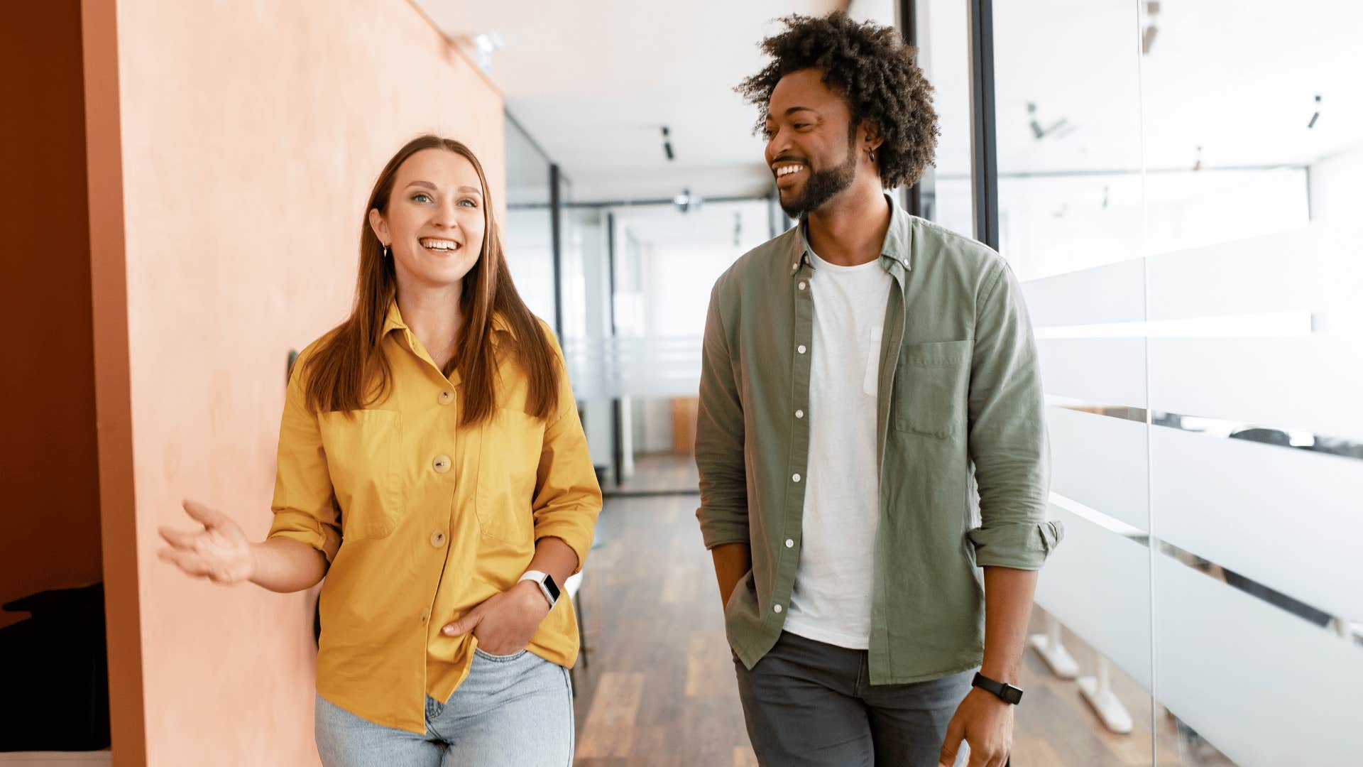 man and woman walking while smiling together 