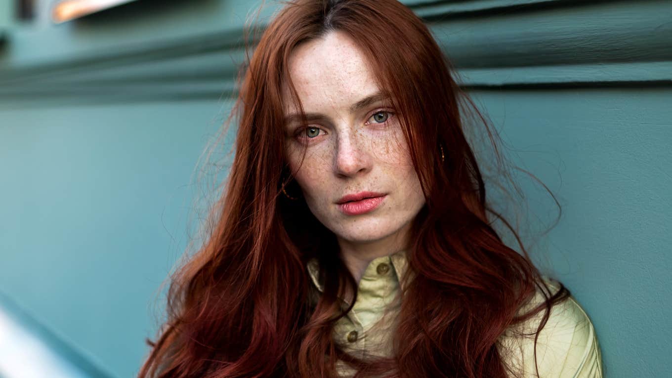 Woman freckled face close up.