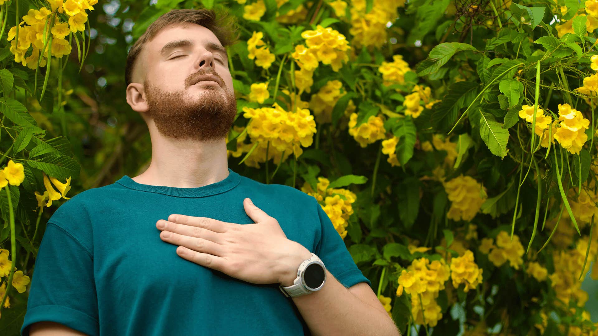 man putting hand over heart and calming himself 