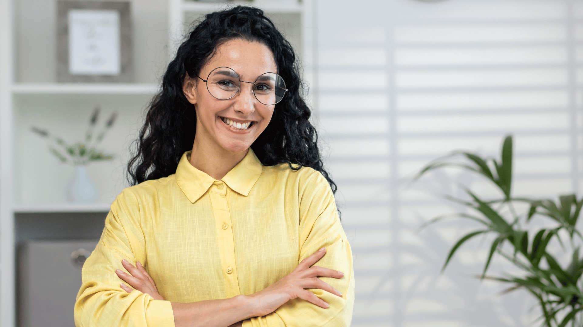 woman crossing arms while smiling 