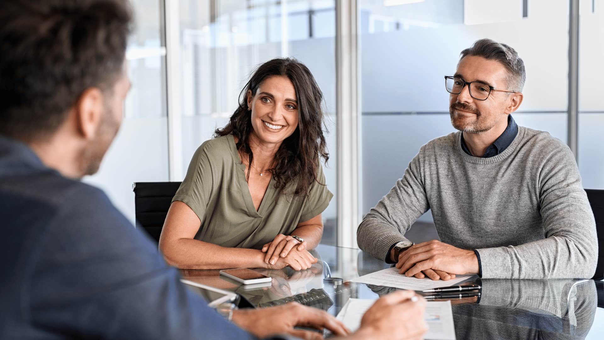 woman leaning forward listening to coworker 