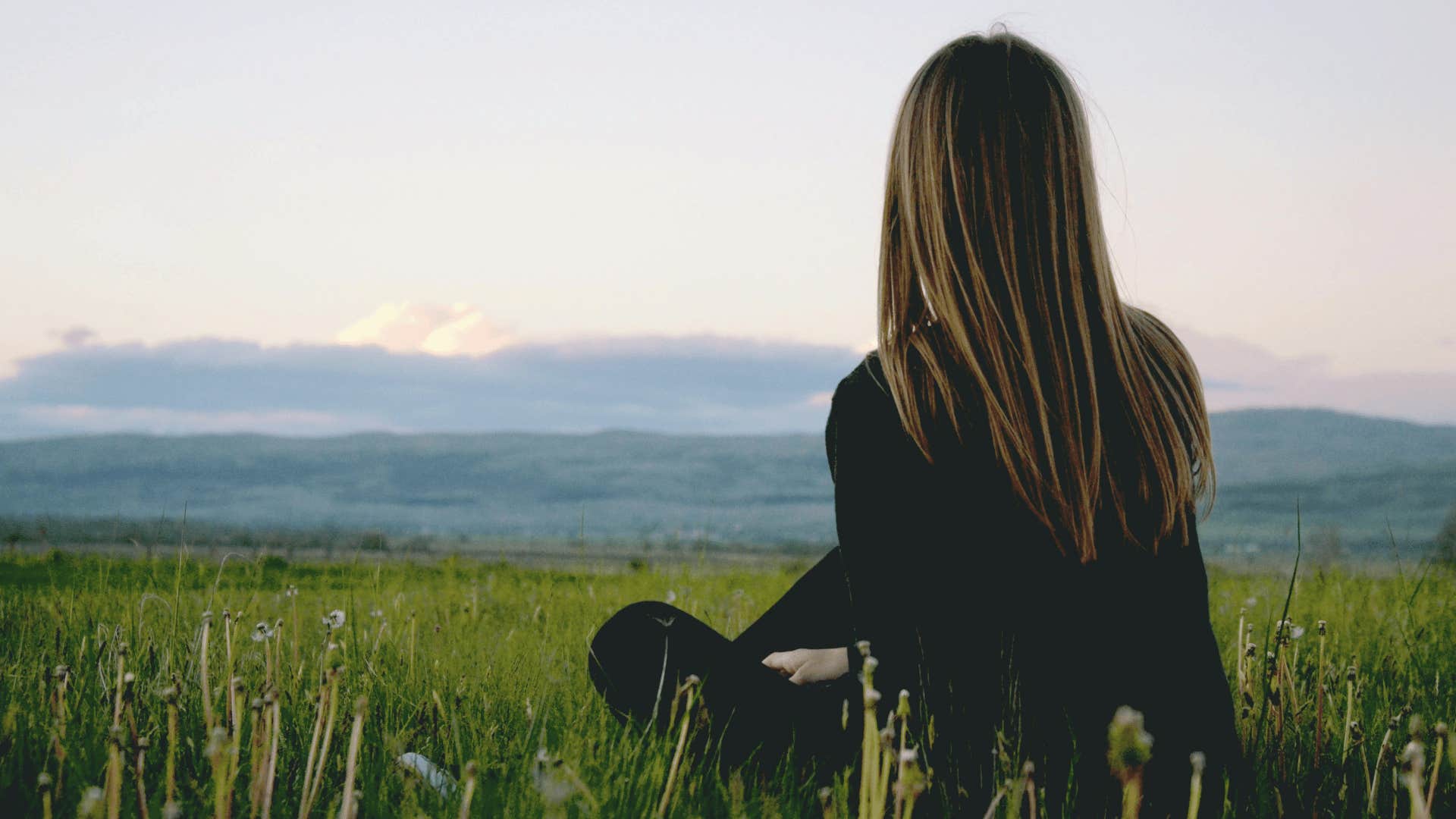 woman sitting looking at mountains